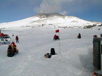 snowmobiles carry geologists up Erebus