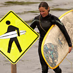Lori carrying her surf board